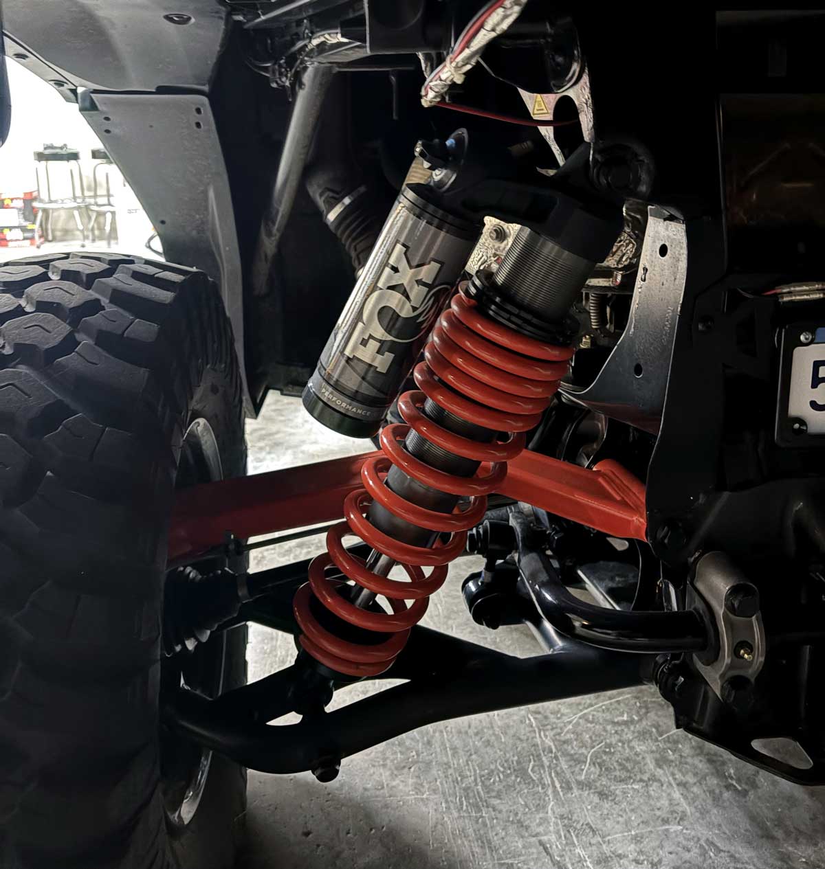 FOX shock absorber and red coil spring on off-road vehicle