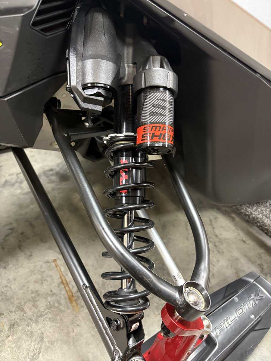 Close-up of snowmobile rear suspension shock and coil spring