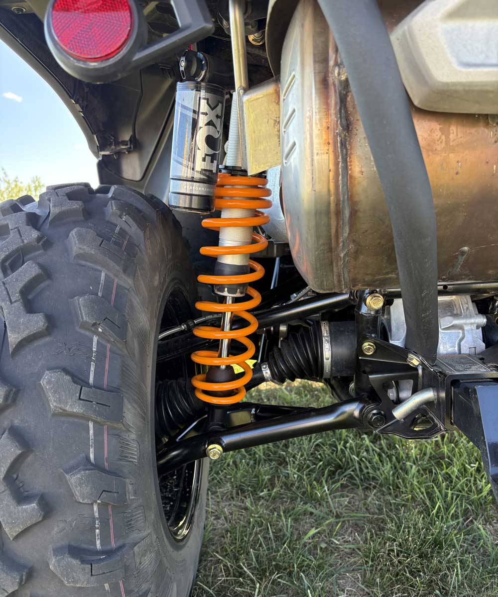 Off-road vehicle rear suspension with FOX shock and orange spring