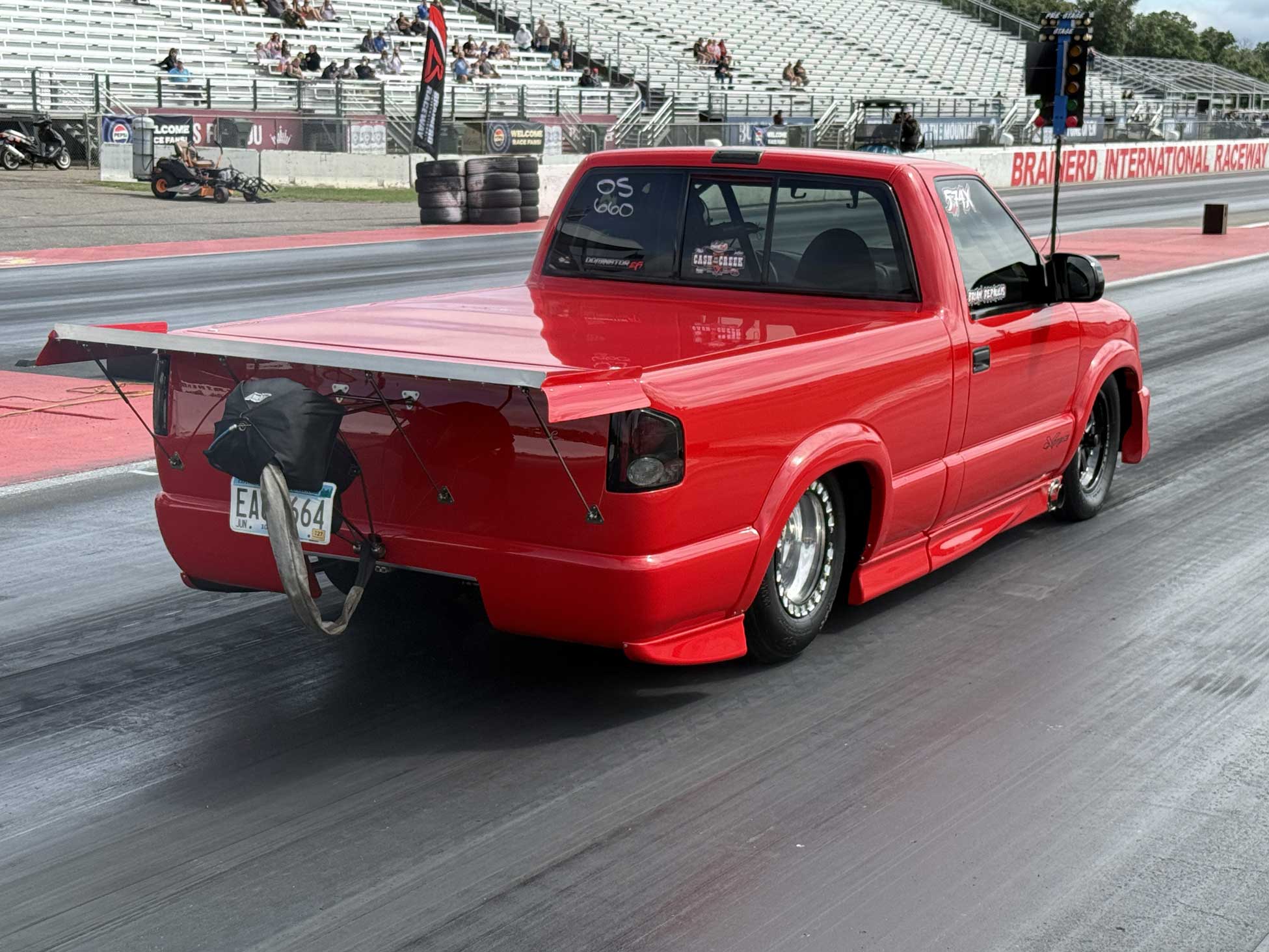 Red drag racing pickup truck at starting line